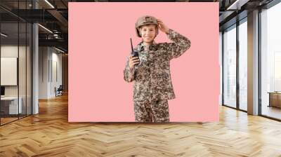 Teenage soldier with walkie-talkie on pink background Wall mural