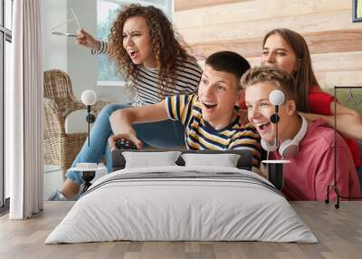 Teenagers playing video game at home Wall mural