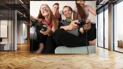 Teenagers playing video games at home Wall mural