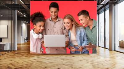 Teenagers with modern laptop on color background Wall mural