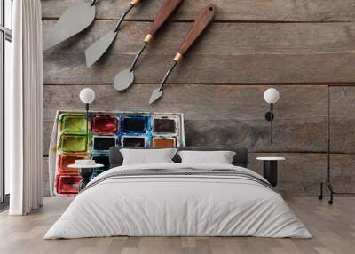 Tools and paints of professional artist on wooden table Wall mural