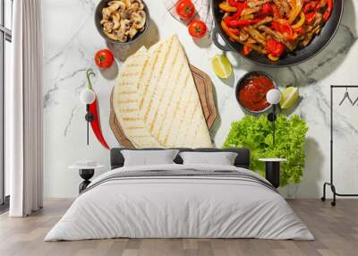 Tortillas and ingredients for tasty Fajitas on light background Wall mural