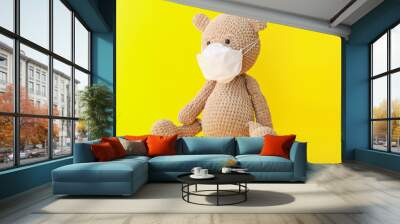 Toy bear with medical mask on color background Wall mural