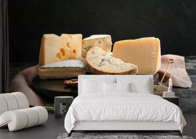 Tray with different types of cheese, walnuts and honey on dark background Wall mural