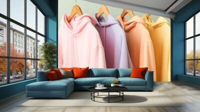 trendy hoodies hanging near green wall Wall mural