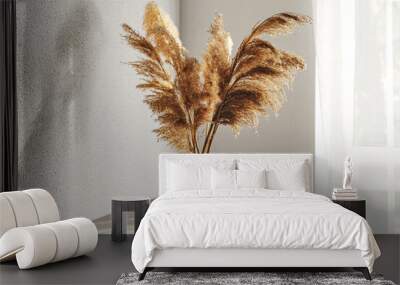 Vase with dry common reeds on table near white wall and window Wall mural