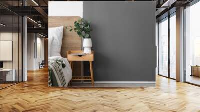 Vase with eucalyptus, devices and magazine on wooden table in bedroom Wall mural