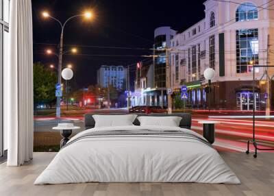 View of city road with street lights and buildings at night Wall mural