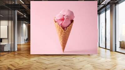 Waffle cone with delicious strawberry ice-cream on color background Wall mural