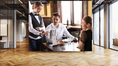 Waiter taking order in restaurant Wall mural