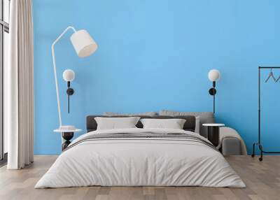 White standing lamp and sofa near blue wall Wall mural