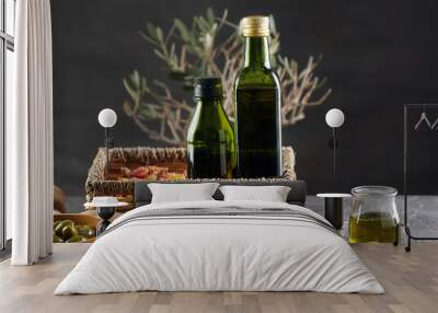 Wicker basket with bottles of olive oil on table Wall mural