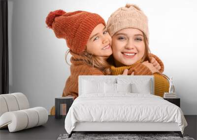 Woman and her little daughter in winter clothes on white background Wall mural