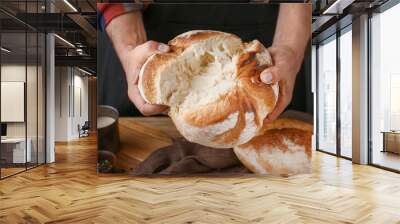 Woman breaking fresh bread, closeup Wall mural