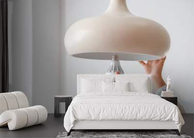 Woman changing light bulb in hanging lamp at home, closeup Wall mural