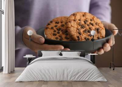 Woman holding bowl with delicious cookies, closeup Wall mural