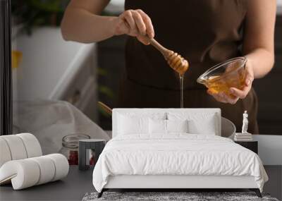 Woman making tasty granola bars in kitchen Wall mural