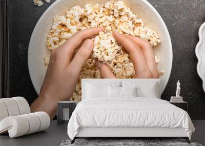 Woman making tasty popcorn balls on dark background, top view Wall mural