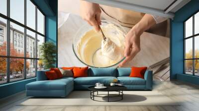 Woman preparing tasty Basque burnt cheesecake in kitchen Wall mural