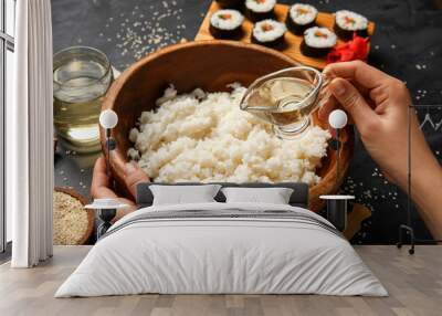 Woman preparing tasty sushi rolls on dark background, closeup Wall mural