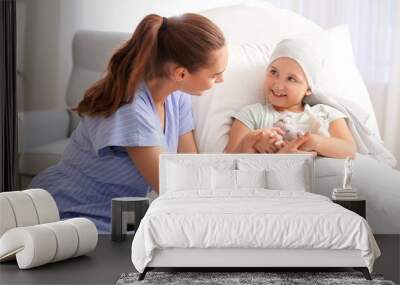 Woman visiting her daughter who is undergoing course of chemotherapy in clinic. Childhood cancer awareness concept Wall mural