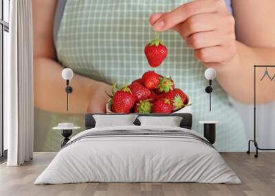 Woman with bowl of red strawberry, closeup Wall mural