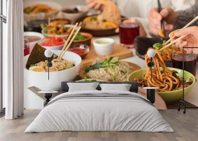 Woman with friends eating tasty Chinese food at table Wall mural