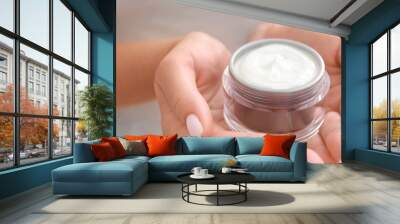 Woman with jar of cosmetic cream, closeup Wall mural