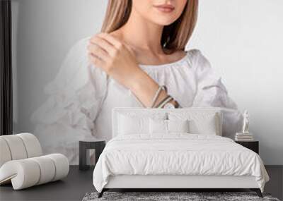 Woman with stylish wrist watch on white background Wall mural