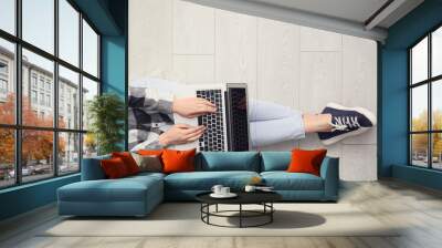 Woman working on modern laptop at home Wall mural