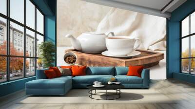 Wooden board with cup of tasty hojicha green tea and pot on table Wall mural