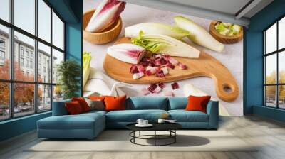 Wooden board with fresh ripe endive on light background Wall mural