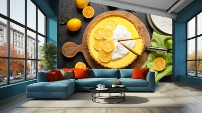 Wooden board with tasty baked lemon pie and fresh fruits on black background Wall mural