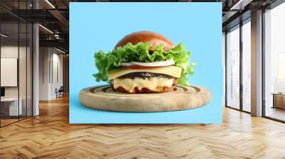 Wooden board with tasty burger on blue background Wall mural