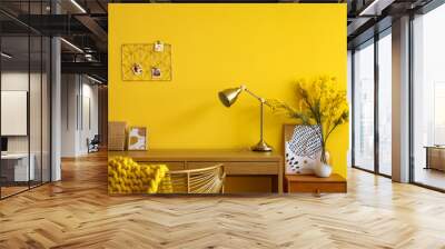 Wooden desk with golden lamp near yellow wall Wall mural