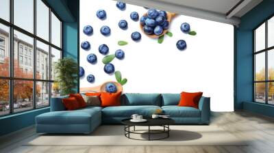 Wooden spoons with ripe blueberries on white background Wall mural