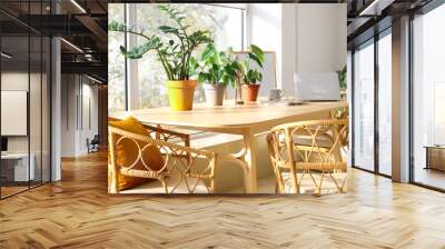 Wooden table with laptop and houseplants in light living room Wall mural