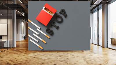 Wooden word STOP and pack of cigarettes on grey background.Stop smoking concept. Wall mural