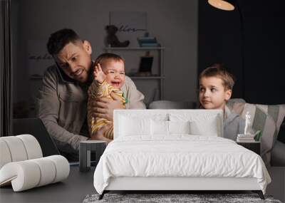 Working father with little children late at home Wall mural