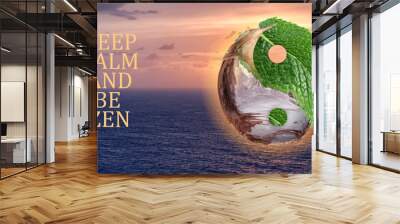 Yin-yang symbol and text KEEP CALM AND BE ZEN against beautiful sea at sunset Wall mural