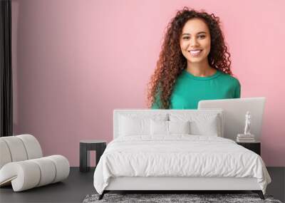 young african-american woman with laptop on pink background Wall mural