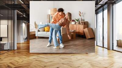 Young couple dancing in room on moving day Wall mural