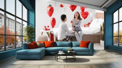 Young couple with balloons in bedroom on Valentine's Day Wall mural