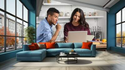 Young couple with laptop in kitchen Wall mural