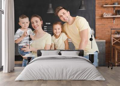 Young family in kitchen at home Wall mural