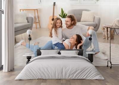 Young family on soft carpet at home Wall mural