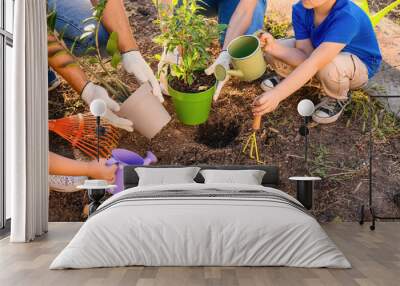 Young family working in garden Wall mural