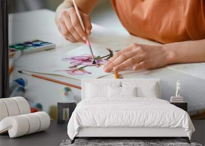 Young female artist painting in workshop, closeup Wall mural