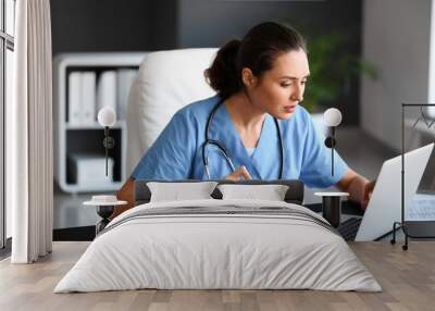 Young female doctor working in clinic Wall mural