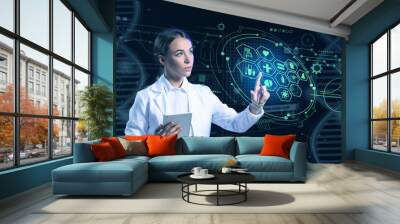 Young female scientist with tablet computer using virtual screen on dark background Wall mural